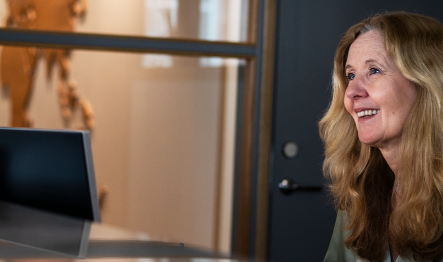 A woman sitting at a desk in an office.