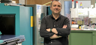 A man standing in front of a machine.