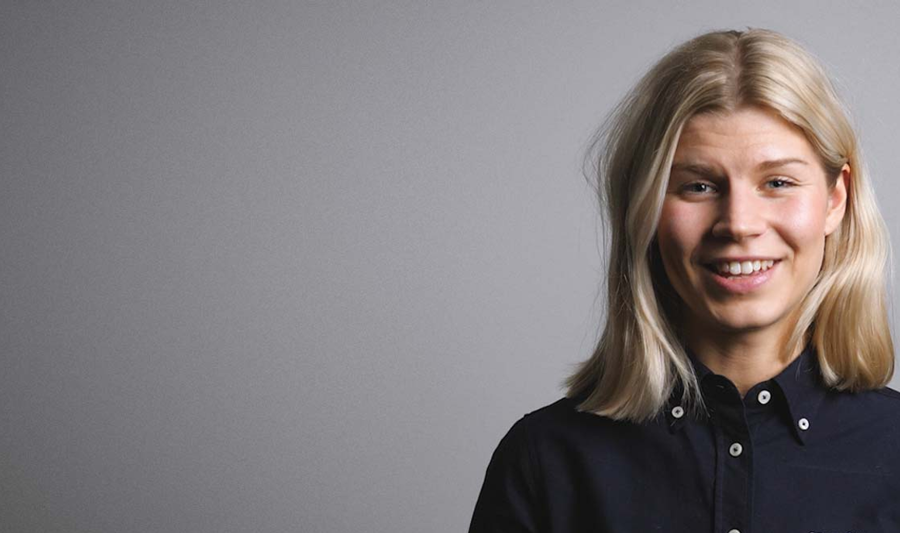 A woman in a black shirt is smiling.