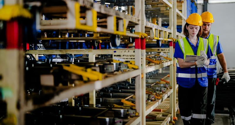 workers checking and inspecting metal machine part items for shipping. male and woman checking the store factory. industry factory warehouse. The warehouse of spare part for machinery and vehicles.