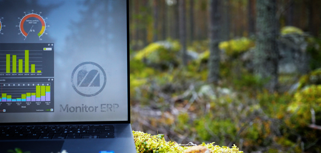 Illustration of Monitor ERP dashboards on a screen placed in nature, symbolizing sustainability.