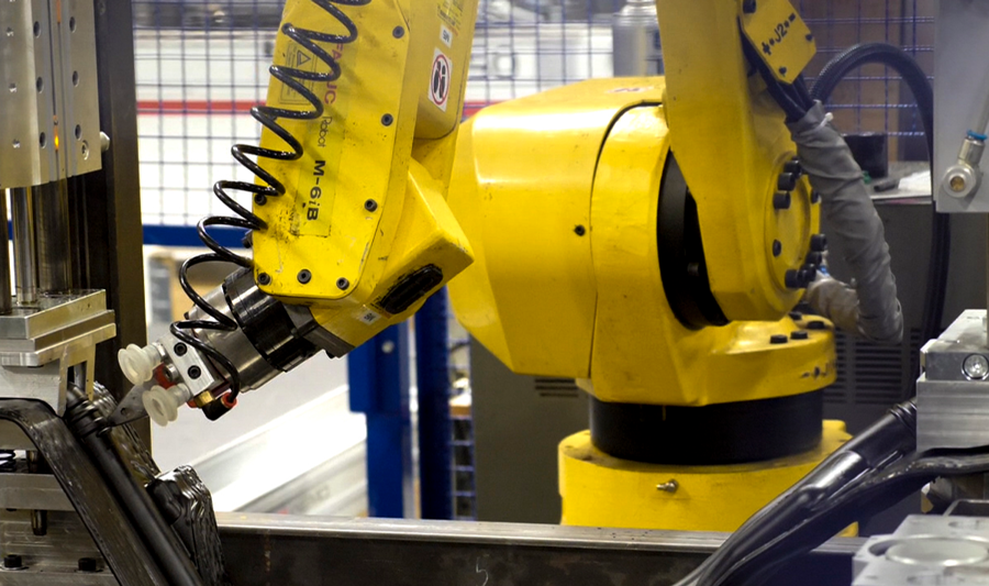 A robot is working on a piece of machinery.