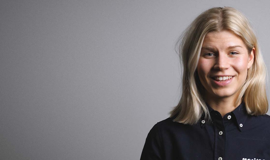 A woman in a black shirt is smiling.