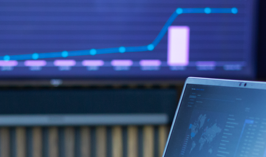 laptop on a table showing Monitor ERP Dashboard