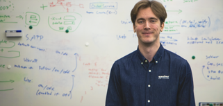 Viktor Rosvall standing in front of a white board