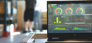 Monitor ERP dashboard displayed on a laptop in a factory environment