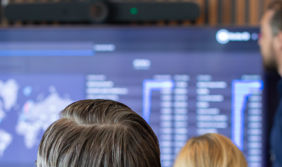 A man at Monitor ERP giving a presentation to a group of people about Monitor BI (business intelligence)