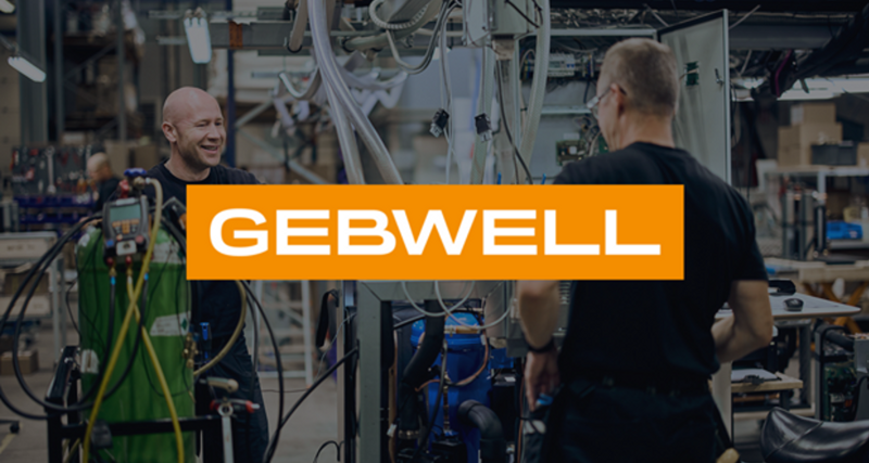 A group of men standing next to each other in a factory.