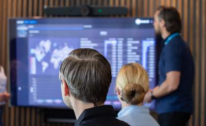 A man at Monitor ERP giving a presentation to a group of people about Monitor BI (business intelligence)