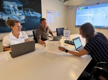 Three people in a room.