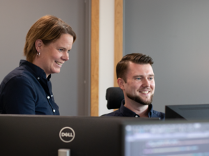 A man and a woman looking at a computer screen together.