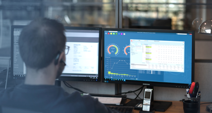 A man sitting in front of a computer monitor.