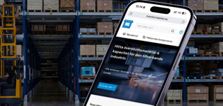 A cell phone in the middle of a warehouse.