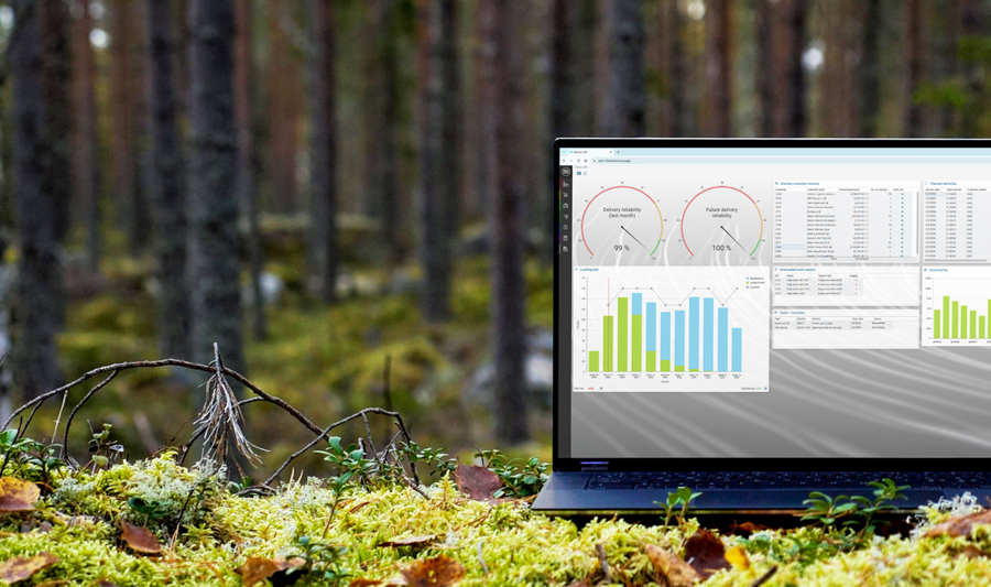 A laptop computer with Monitor ERP dashboard (sustainability functions) sitting on top of a moss covered field.