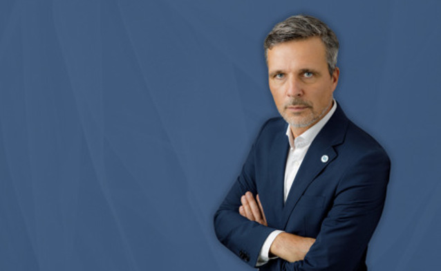 Maciej Swienton, CEO Monitor ERP Poland, on blue background.