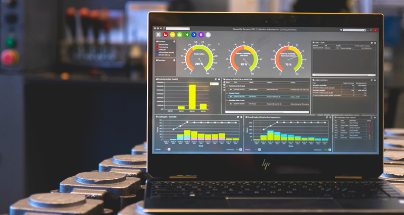 Monitor ERP dashboard displayed on a laptop in a factory environment