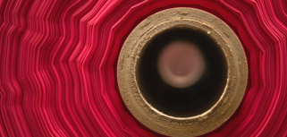 A close up of a red and gold object.