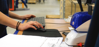 A man working on a computer in a factory.