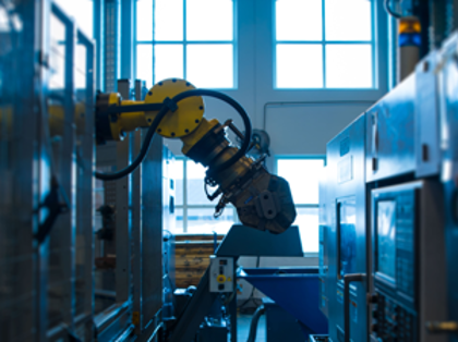 A robot is working on a machine in a factory.