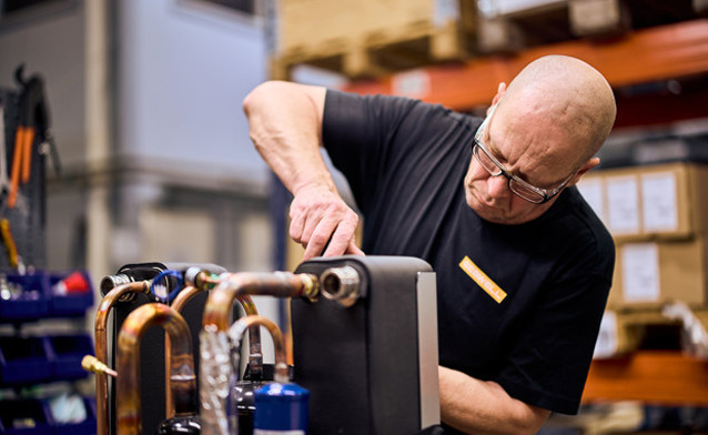 A man working on a machine in a factory.