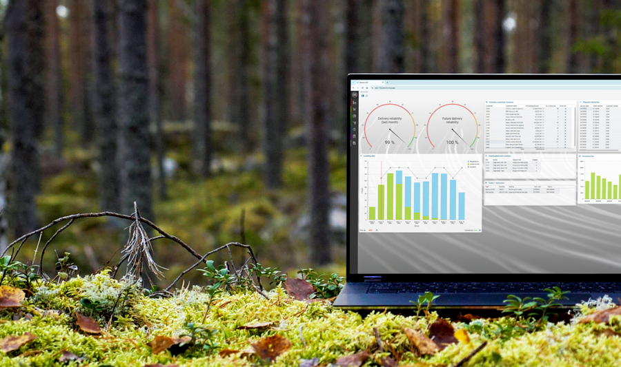A laptop computer with Monitor ERP dashboard (sustainability functions) sitting on top of a moss covered field.