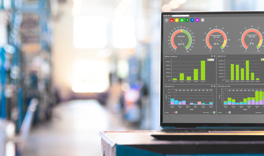 Monitor ERP dashboard displayed on a laptop in a factory environment