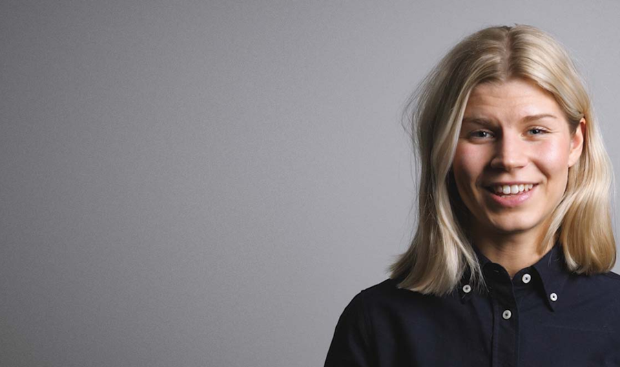 A woman in a black shirt is smiling.