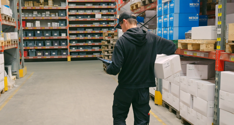 Person walking in a warehouse.