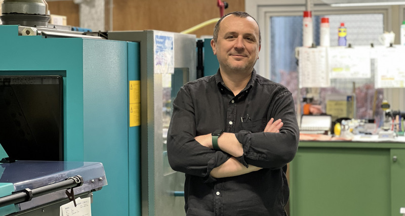 A man standing in front of a machine.