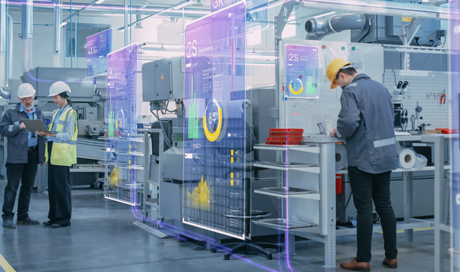 En grupp människor som står runt maskiner.