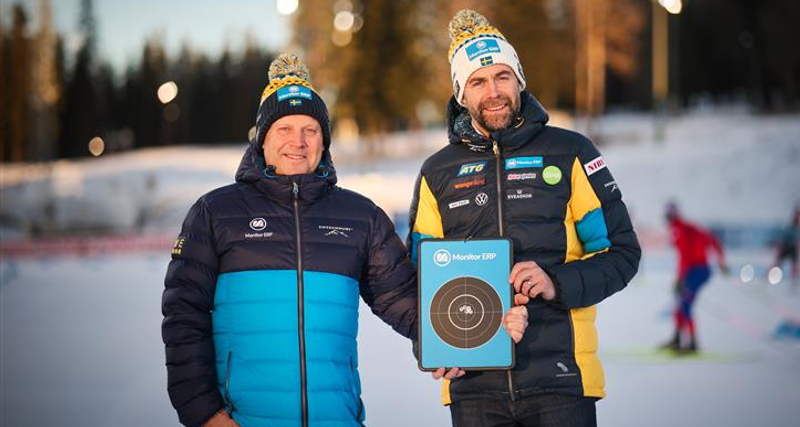 Two men standing next to each other holding a plaque.