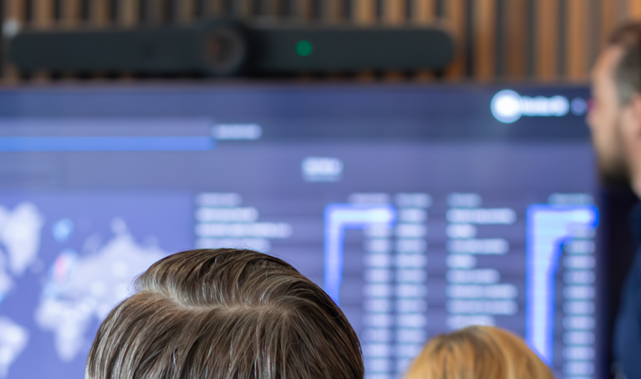 A man at Monitor ERP giving a presentation to a group of people about Monitor BI (business intelligence)