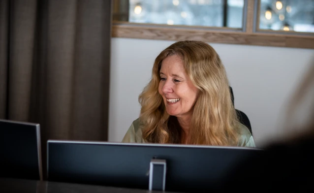 A woman sitting in front of a laptop computer.