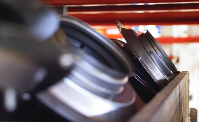A close up of a camera on a wooden box.