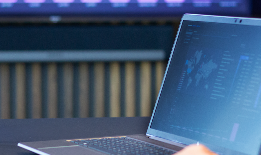 laptop on a table showing Monitor ERP Dashboard