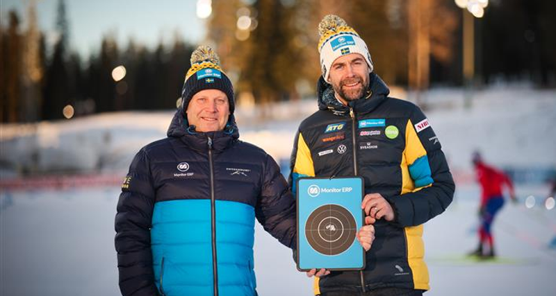 Two men standing next to each other holding a plaque.