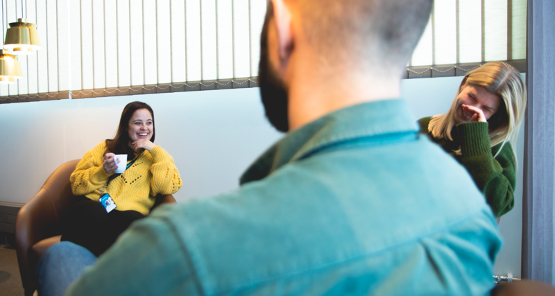 A man and a woman sitting on a couch.