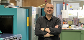A man standing in front of a machine.