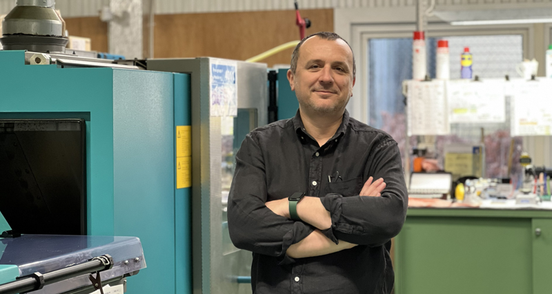 A man standing in front of a machine.