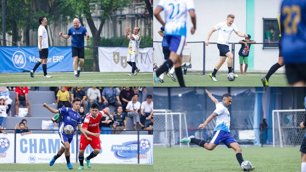 A man in a blue and white football uniform kicking a soccer ball on a green turf field