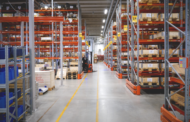 A large warehouse filled with lots of shelves.