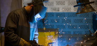 A welder working on a piece of metal.