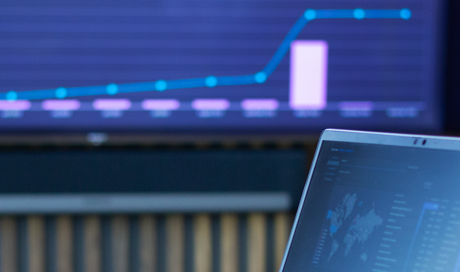 laptop on a table showing Monitor ERP Dashboard.