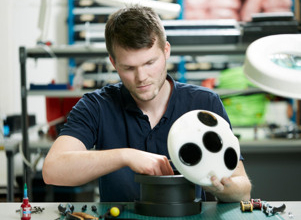 Man in factory working with tool.