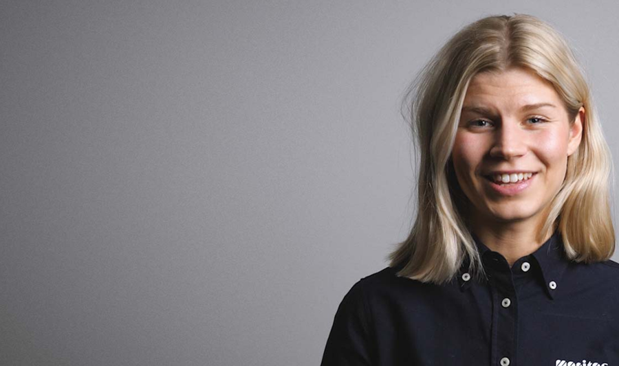 A woman in a black shirt is smiling.