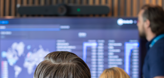 A man at Monitor ERP giving a presentation to a group of people about Monitor BI (business intelligence)