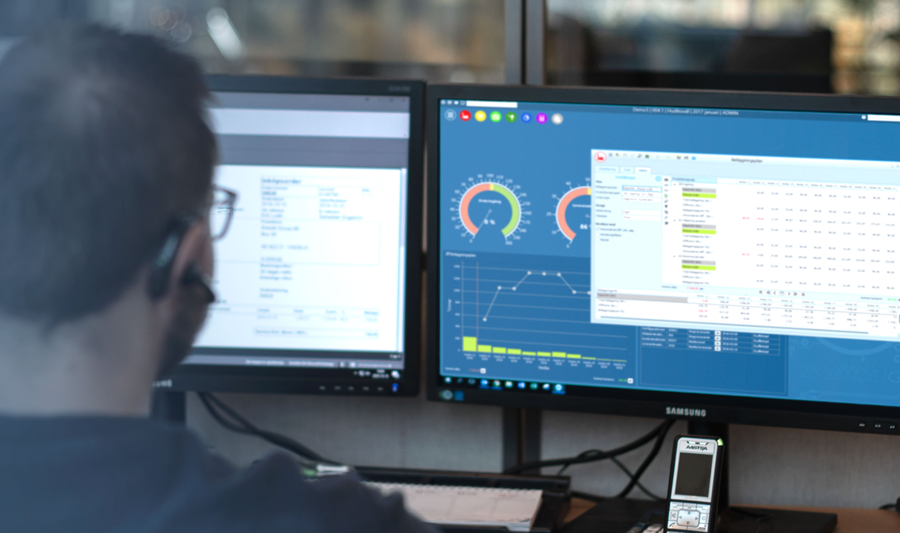 A man sitting in front of a computer monitor.