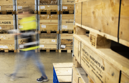 A blurry photo of a man in a warehouse.