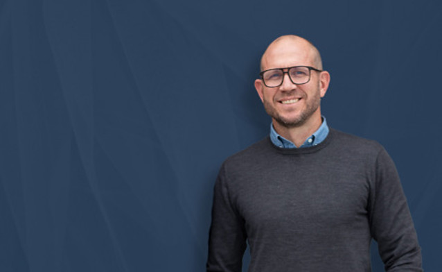 Johan Holmsten - Global Sales Manager z firmy Monitor ERP, na niebieskim tle.
