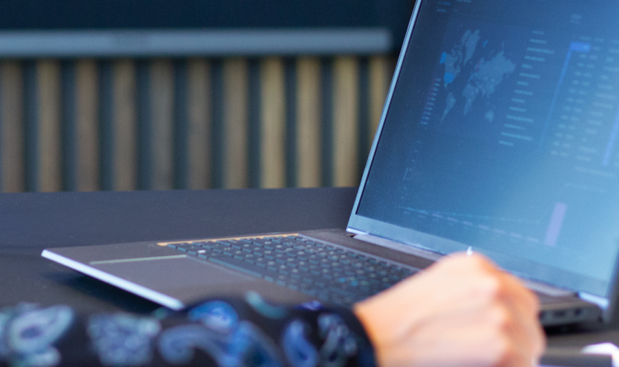 laptop on a table showing Monitor ERP Dashboard
